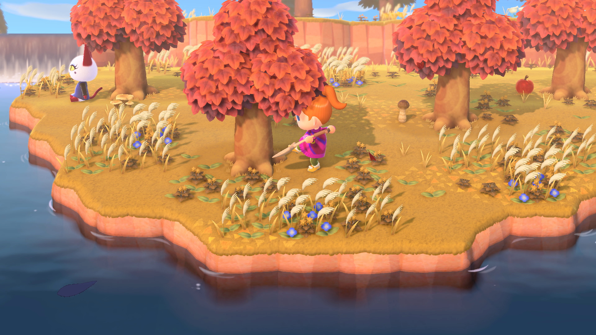 Una escena de isla con árboles de hojas naranjas, un personaje con una herramienta y un gato. El agua rodea la isla.