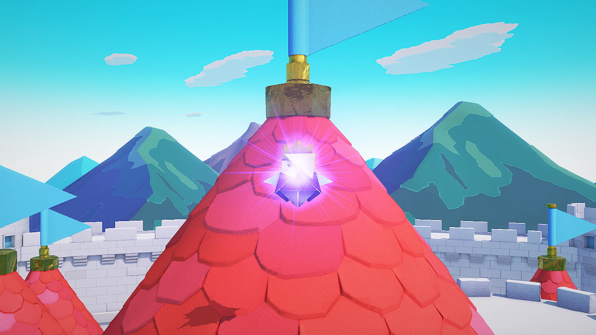 Kreskówkowy zamek z czerwonymi dachami, niebieskimi flagami, białymi murami i górami w tle pod błękitnym niebem z chmurami.