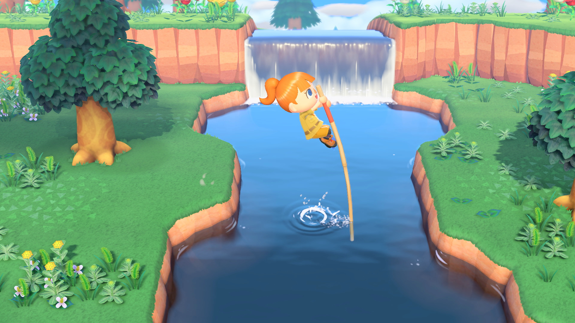 Eine Zeichentrickfigur springt mit einer Stange über einen Fluss, im Hintergrund ein Wasserfall. Auf beiden Seiten grünes Gras und Bäume.