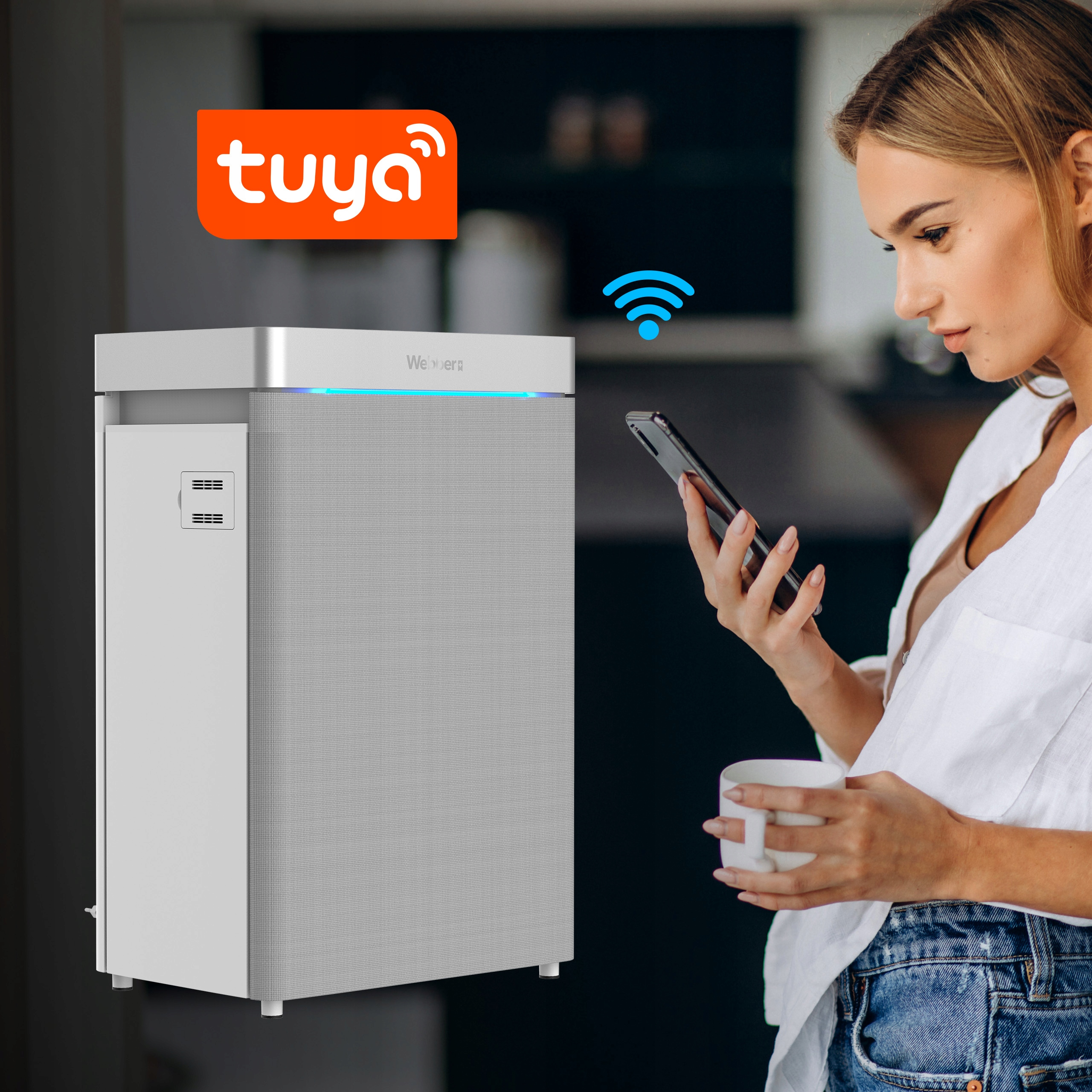Kobieta z telefonem, ikoną wifi, oczyszczaczem powietrza, logo Tuya. Biała koszula, dżinsy. Kubek kawy. Technologia smart home.