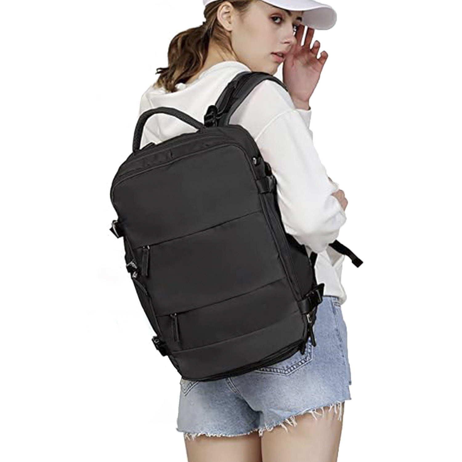 Una donna con cappellino bianco e felpa con cappuccio, che porta uno zaino nero. Indossa pantaloncini di jeans, guardando sopra la spalla.