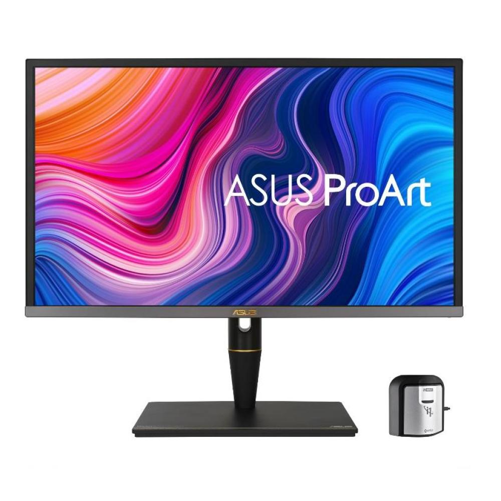 Un monitor ASUS ProArt con una pantalla colorida. Hay un pequeño dispositivo a la derecha. El monitor está sobre una base negra.