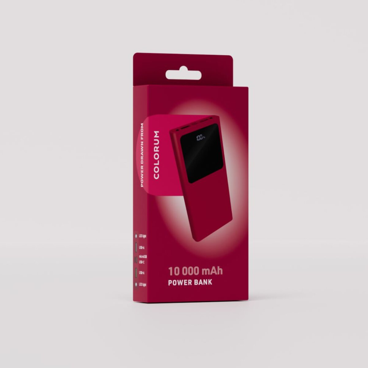 Une banque d'alimentation rouge dans une boîte. La boîte porte la marque 'COLORUM' et des spécifications comme 10 000 mAh. Affiche 100% de charge.