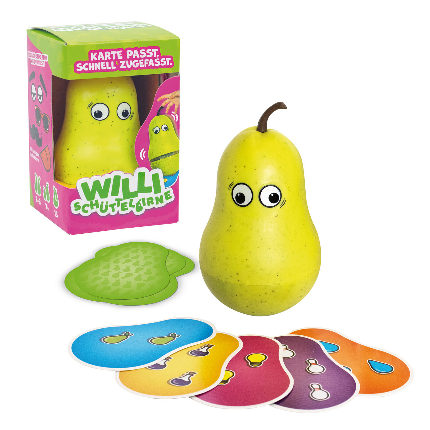 Ein birnenförmiges Spielzeug mit Augen, eine Spielbox, Karten und eine grüne Matte liegen auf einer weißen Oberfläche. Die Box hat Text.