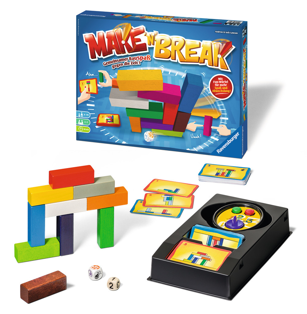 Il gioco 'Make 'n' Break' è mostrato. Include una scatola di gioco, blocchi di legno, dadi, carte e un timer in un vassoio nero. I colori sono vivaci.