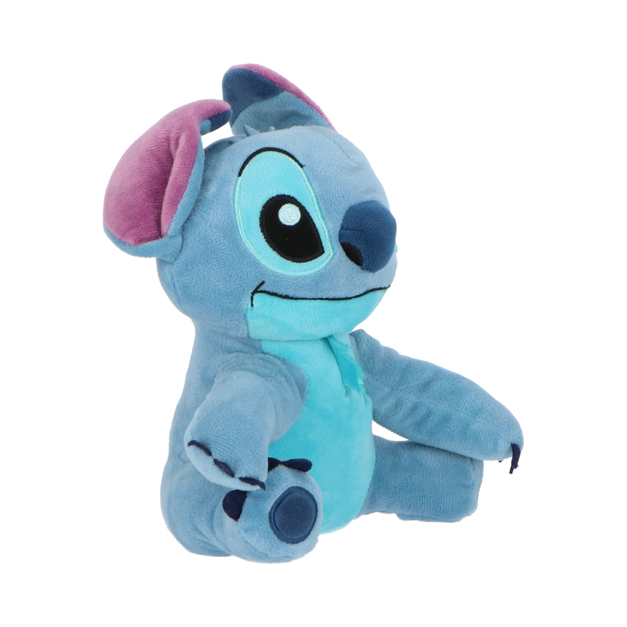 Un peluche azul de Stitch, con orejas grandes, sentado. El fondo es blanco.