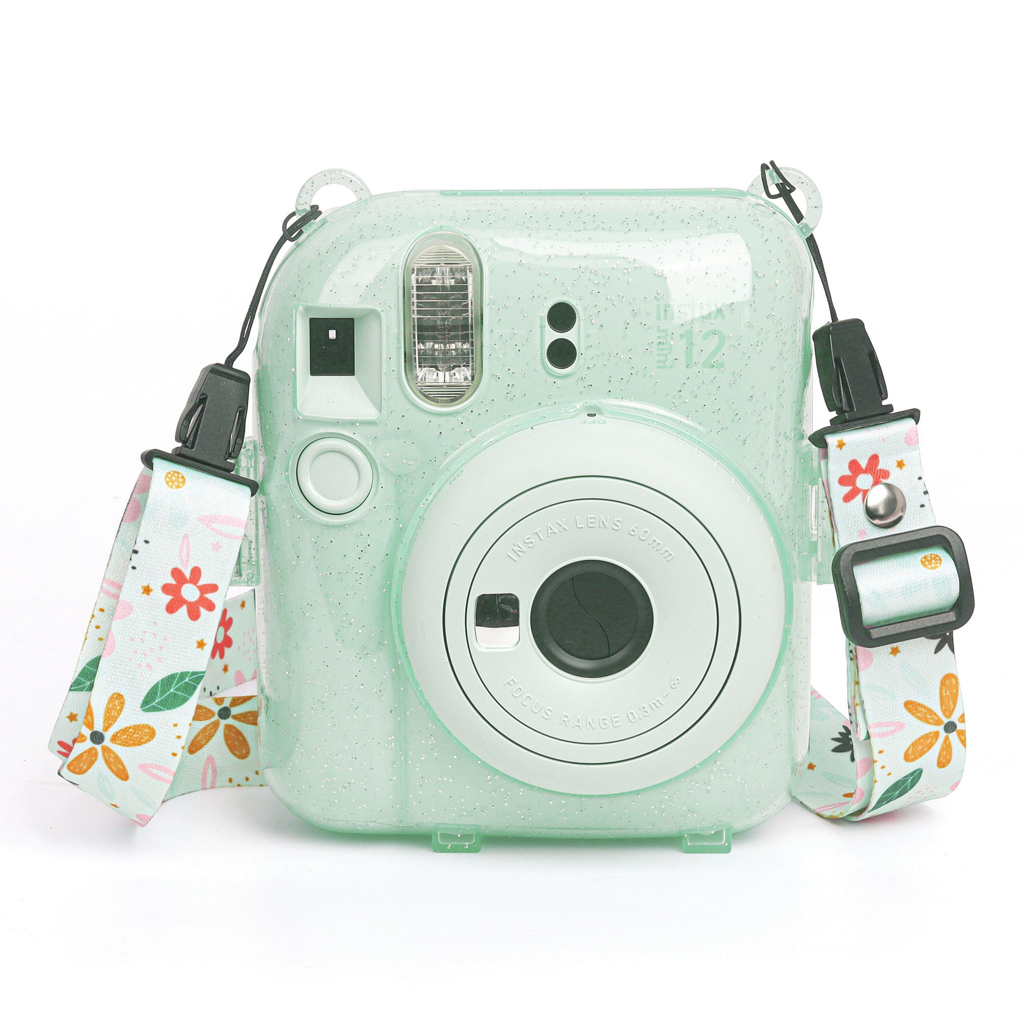 Nane yeşili çiçekli kayışlı Instax kamera. Beyaz arka plan. Kamerada flaş, lens ve düğmeler var. Kayışta çiçekler var.