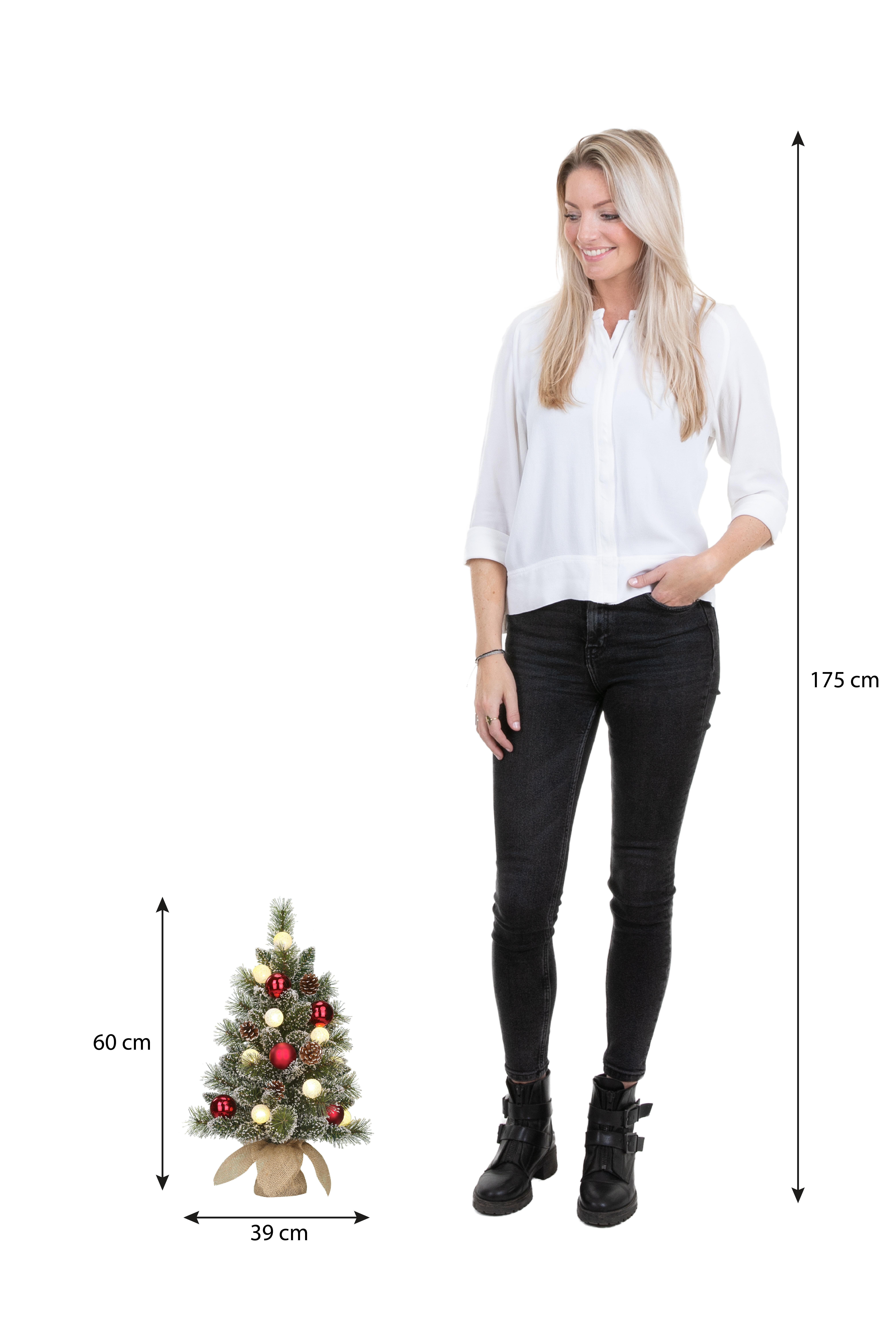 Une femme se tient à côté d'un sapin de Noël. La femme mesure 175 cm. L'arbre mesure 60 cm de haut et 39 cm de large.
