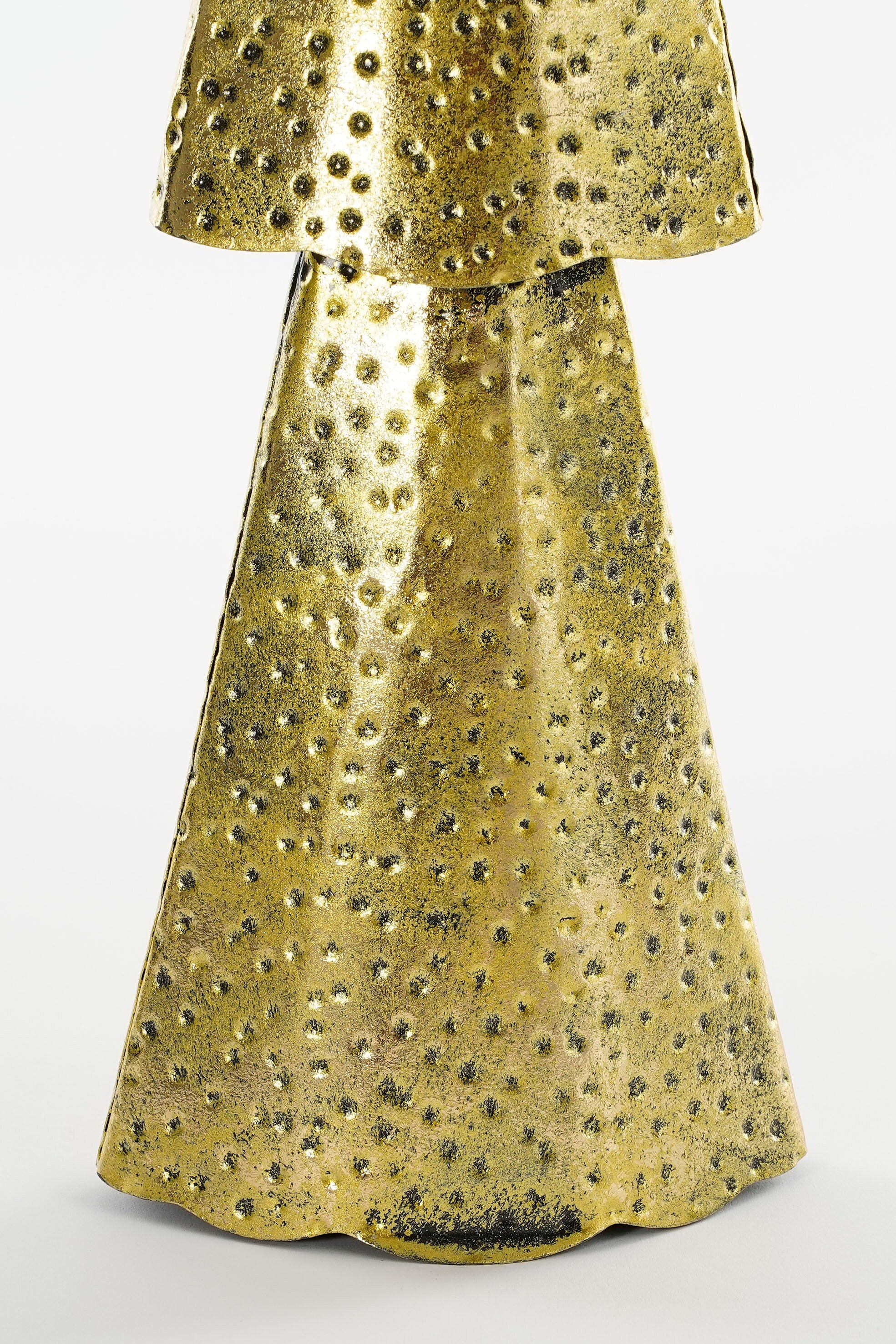 A golden, textured object with a flared base and a wide, layered top against a white background.