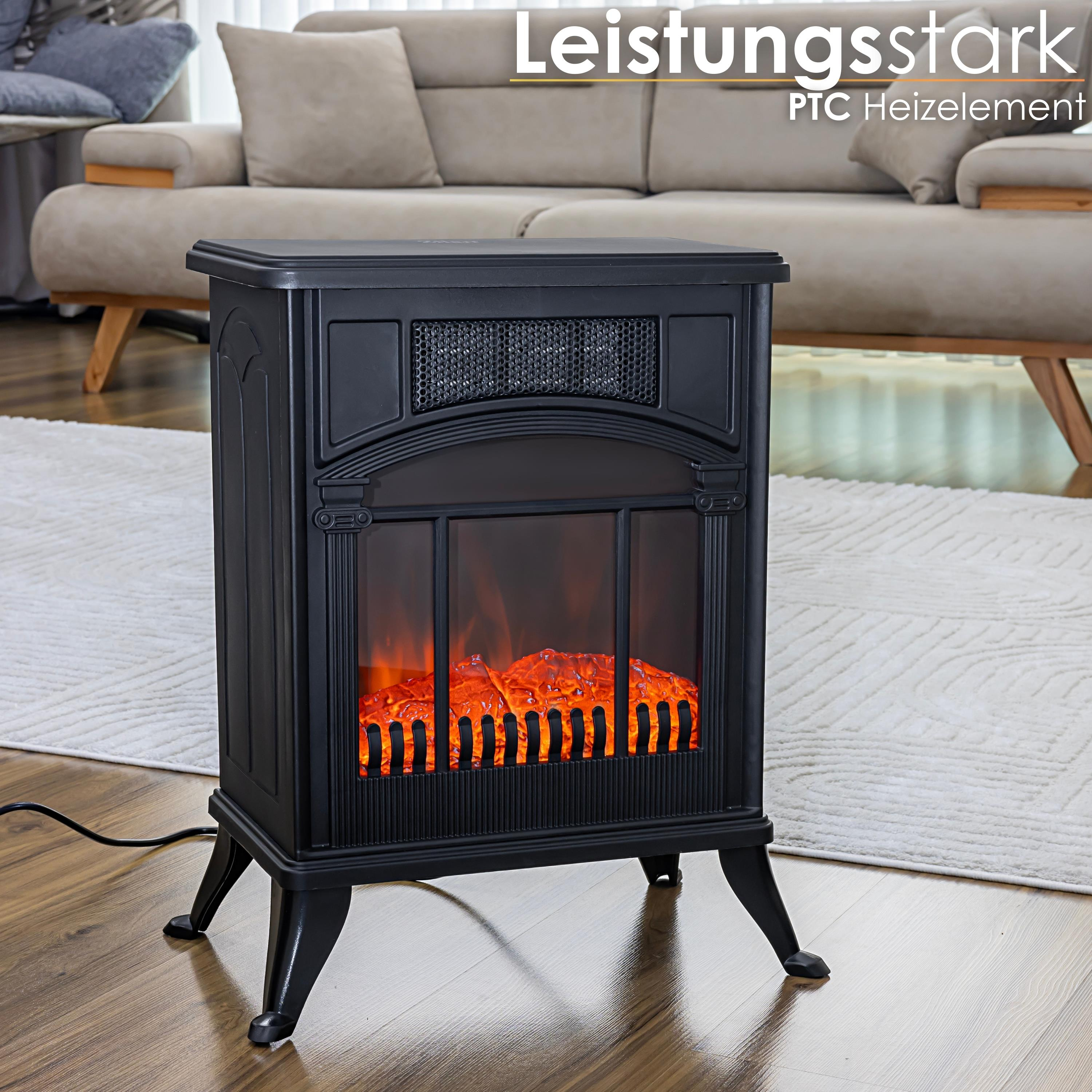 Ein schwarzer elektrischer Kamin mit einem glühenden Flammeneffekt. Er steht auf einem Holzboden vor einem beigen Sofa.