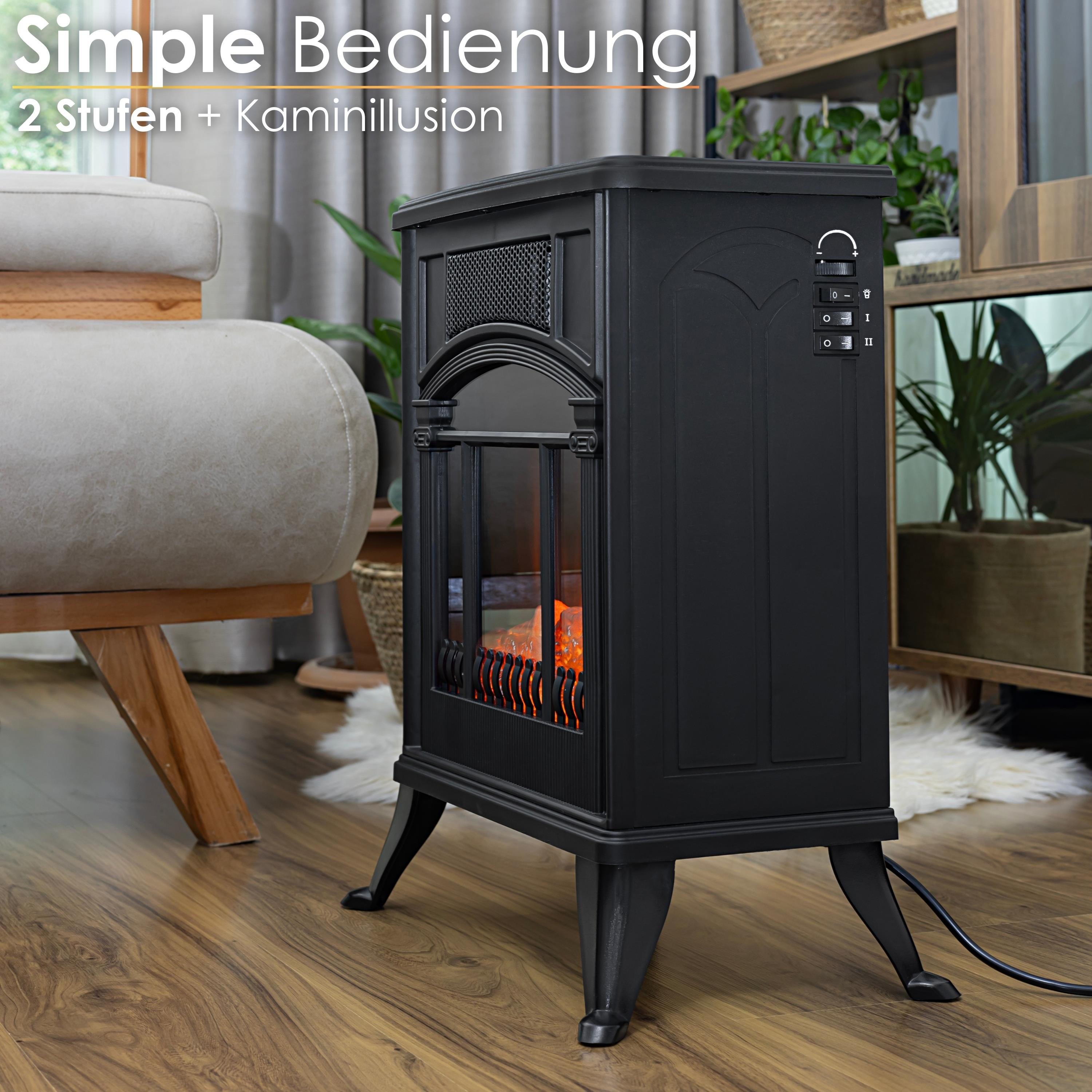 Ein schwarzer elektrischer Kamin mit Leuchteffekt, in einem Raum mit Couch und Pflanzen.