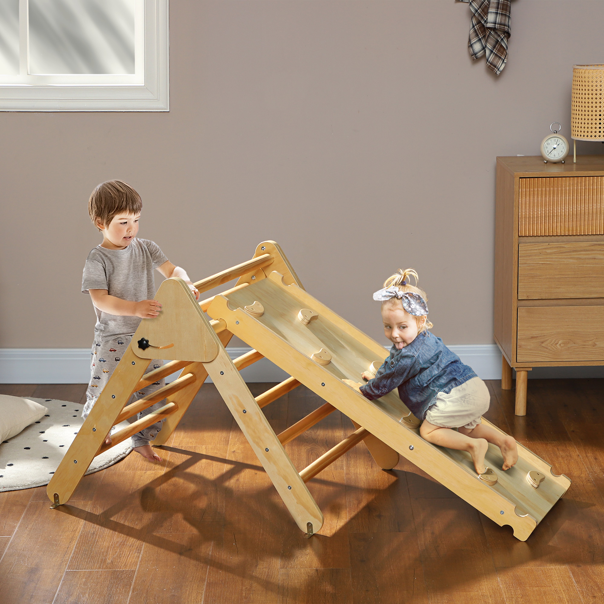 Dos niños pequeños juegan en un marco de escalada de madera. Uno escala, el otro ayuda. Fondo neutro con muebles.