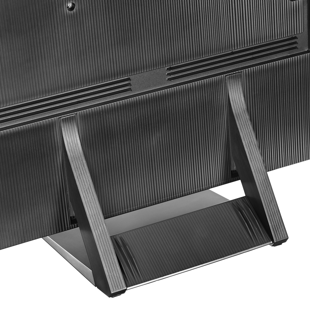 The back of a black TV with a ribbed texture. It has two legs and a stand. The TV is partially visible.
