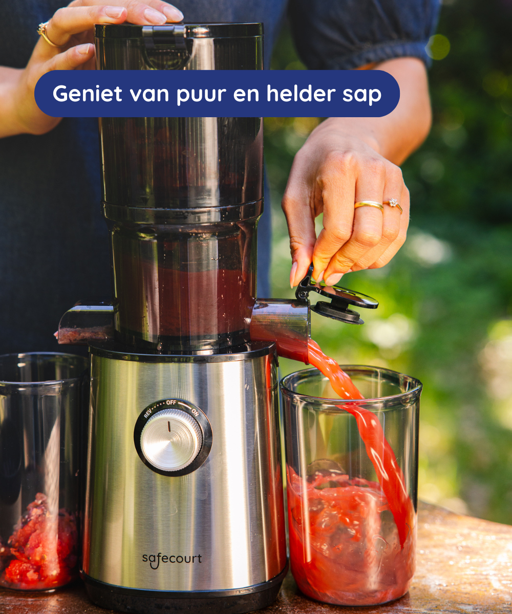 A juicer pours red juice into a glass. A person operates the juicer. Two other glasses are on the table. Green background.