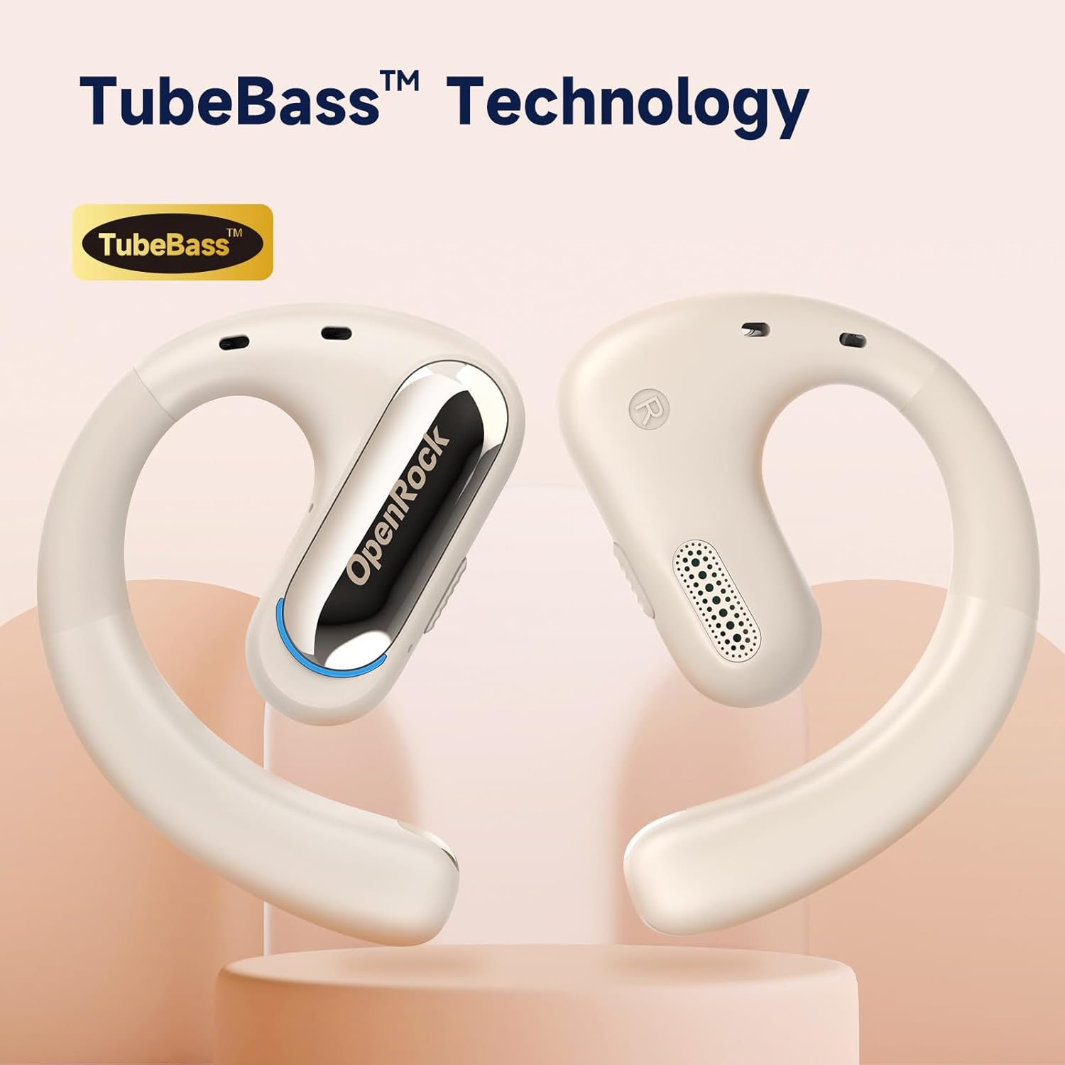 Twee crèmekleurige OpenRock TubeBass-hoofdtelefoons op een standaard, productfoto. Tekst: TubeBass-technologie.