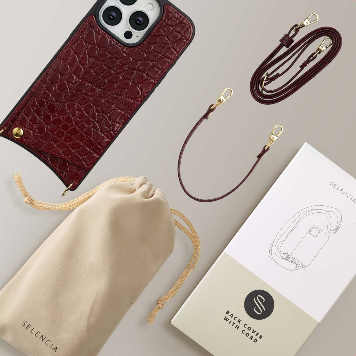 Une coque de téléphone bordeaux avec une lanière et une pochette, ainsi qu'un emballage intitulé "Back Cover With Cord" et "Selencia".