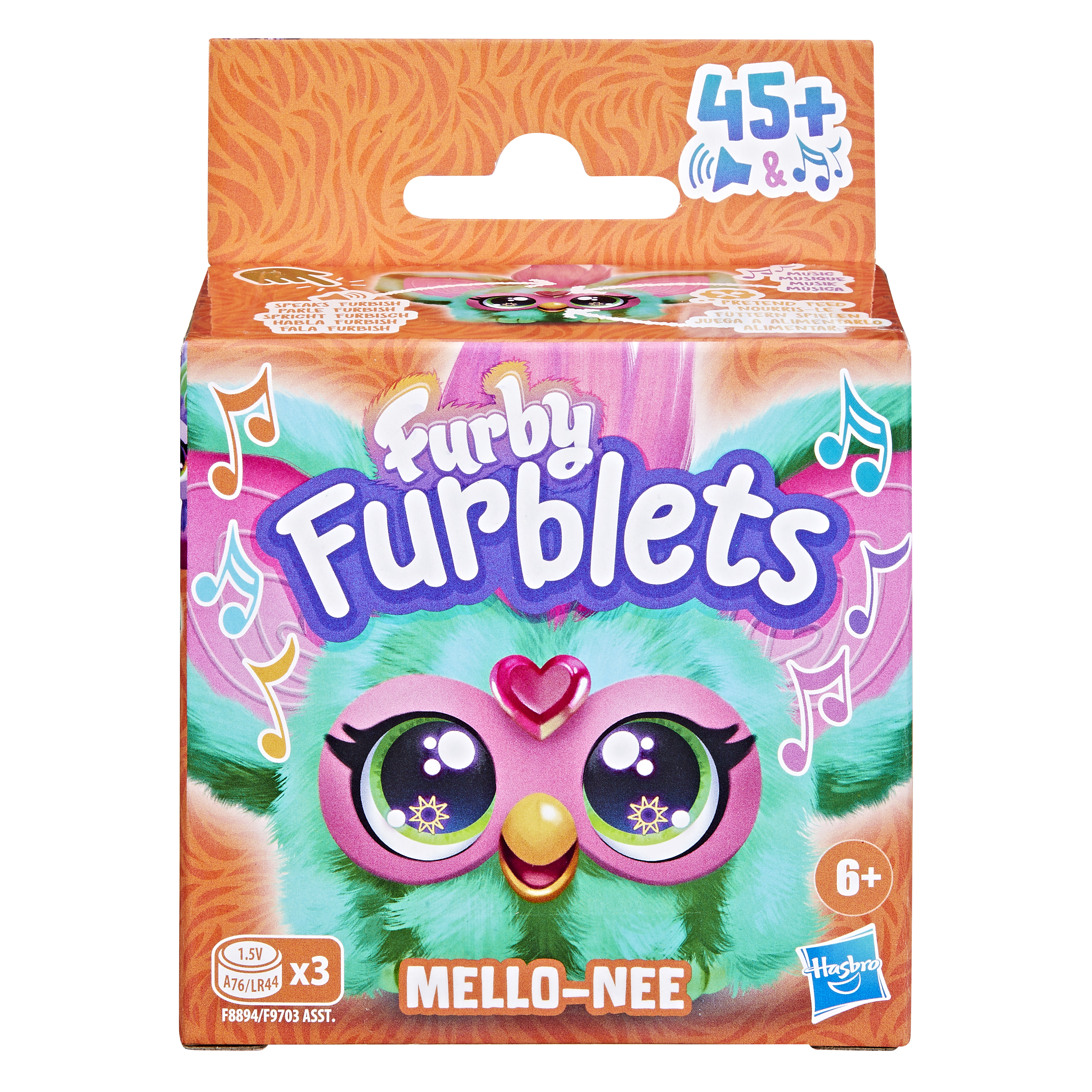 Caja del juguete Furby Furblets. Tiene una cara de Furby, colores rosa y verde azulado, y notas musicales. Dice Mello-Nee.