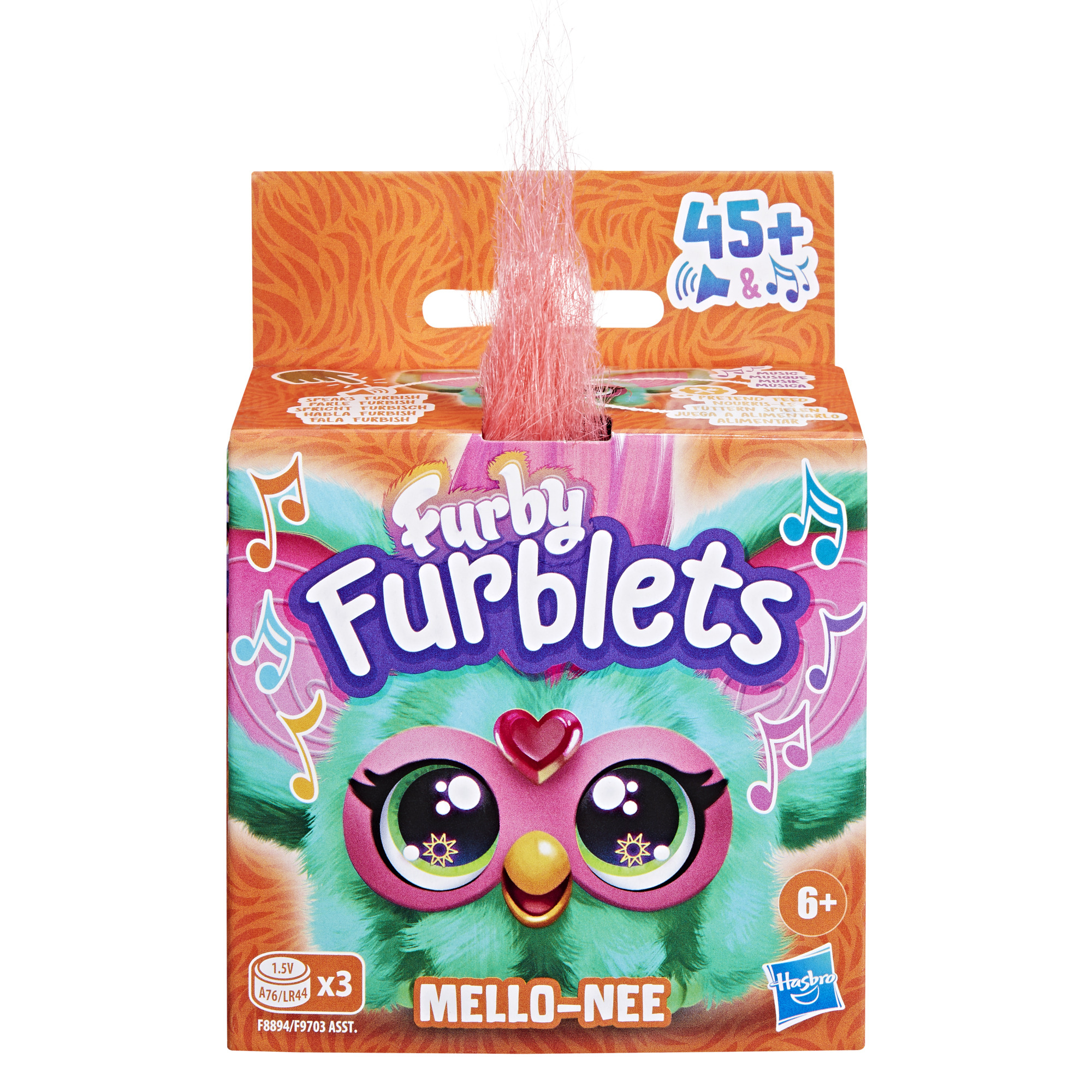 Una caja de juguetes Furblets con una cara de Furby. El texto dice 'Mello-Nee'. Tiene un mechón de pelo rosa.