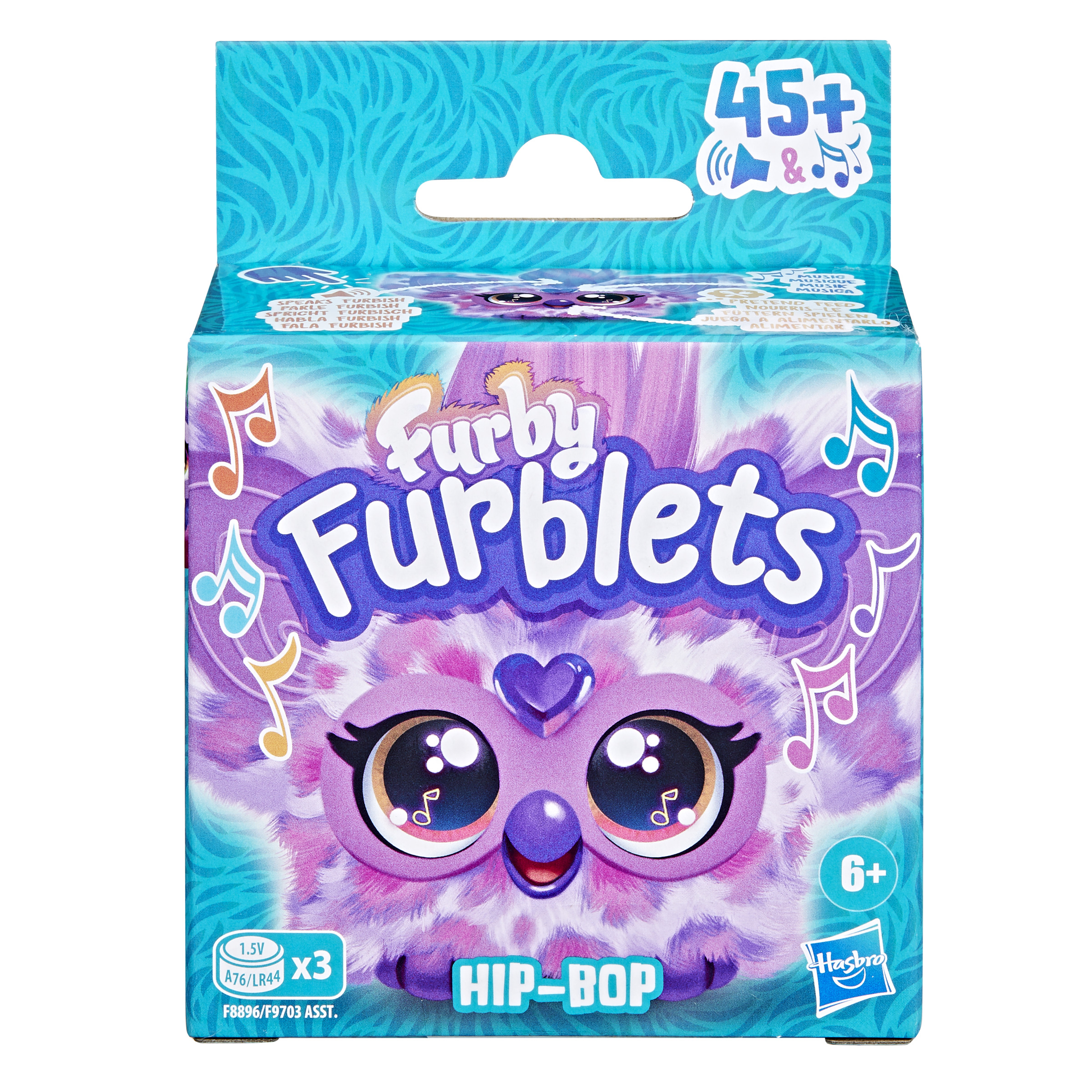 Una caja de Furblets. Tiene una cara de Furby morada con ojos grandes y notas musicales. La caja dice 'HIP-BOP'.