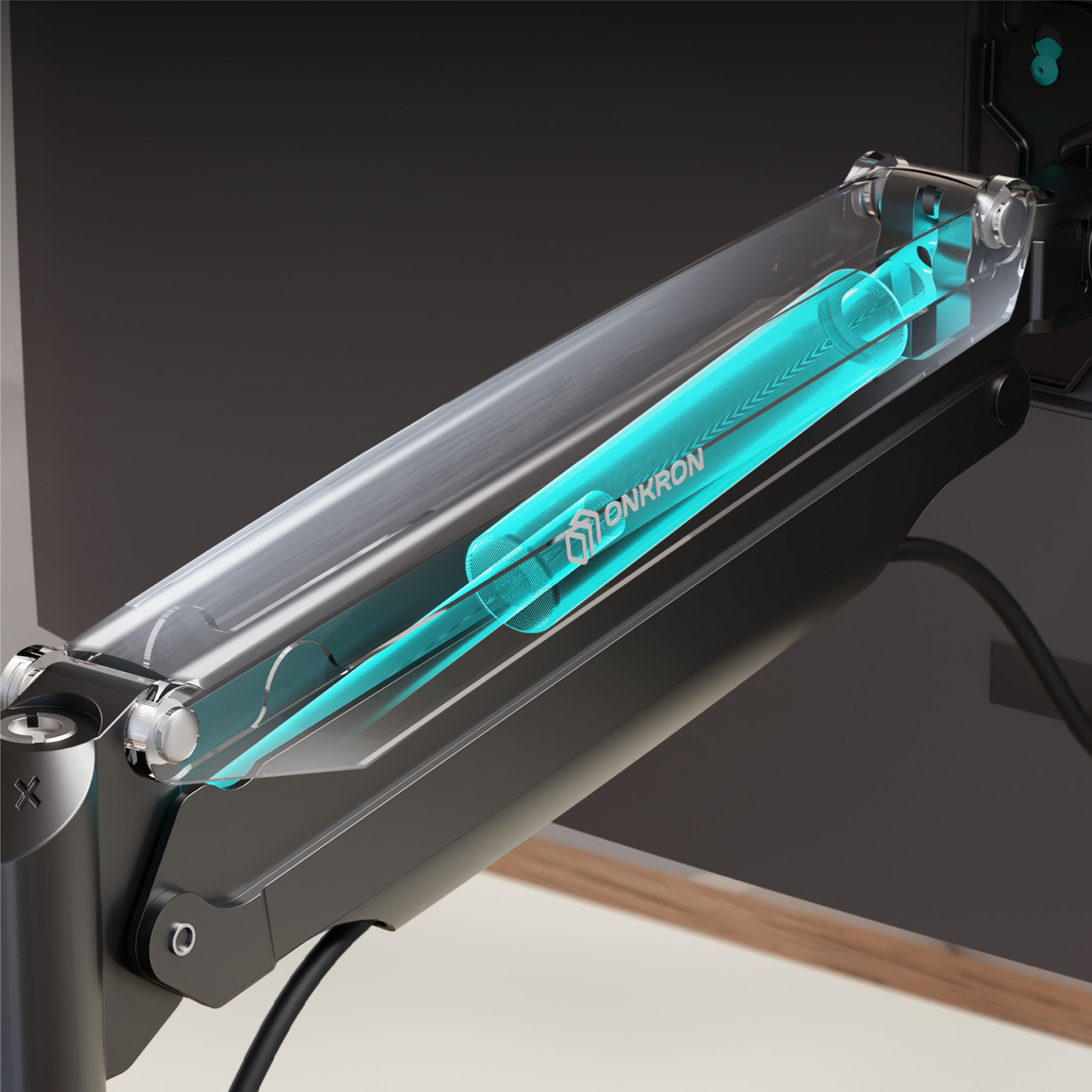 Ramię monitora z przezroczystą osłoną i turkusowym elementem w środku. Widoczna jest nazwa marki ONKRON.