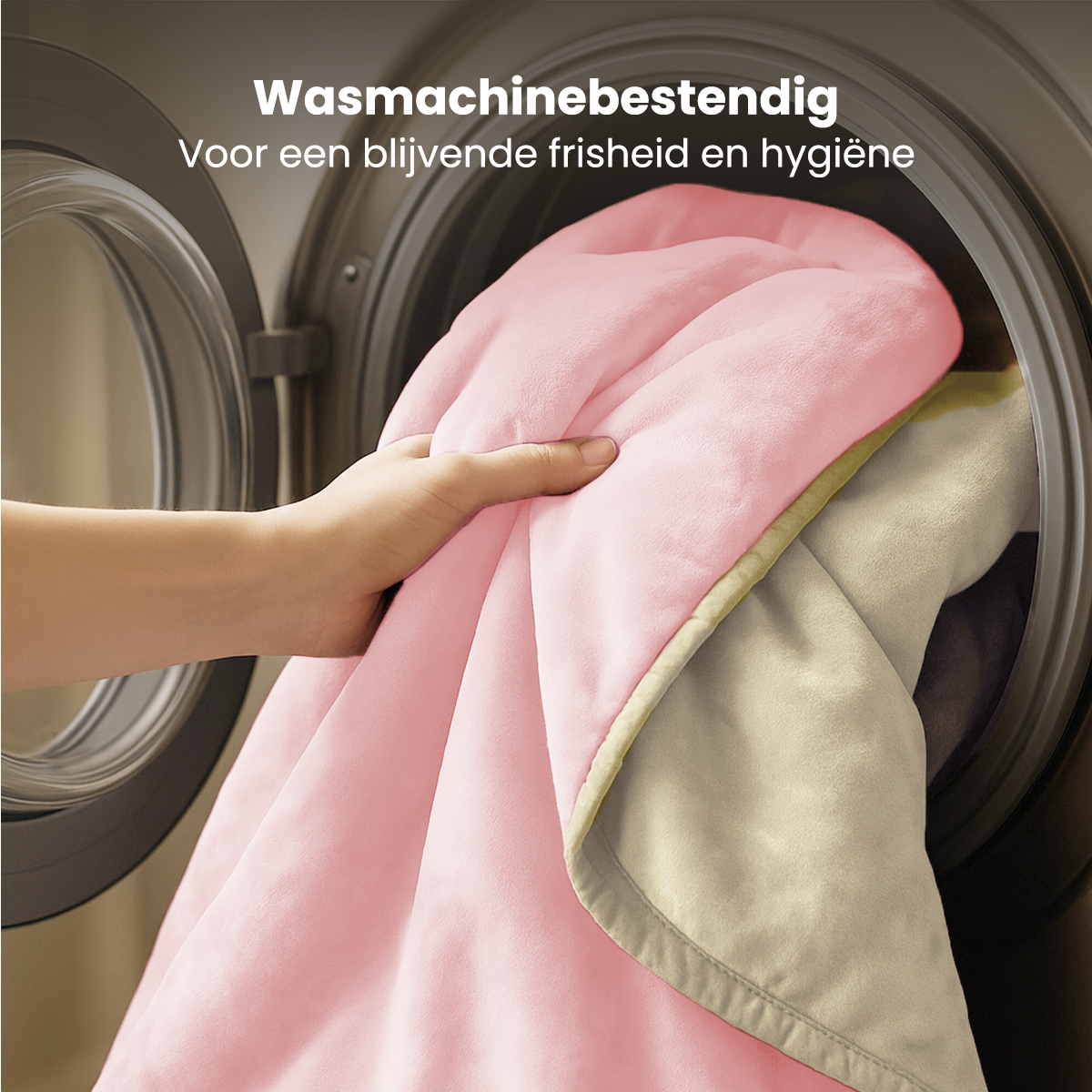 A hand placing a pink blanket into a washing machine. The blanket has a lighter color on the other side. Text is at the top.