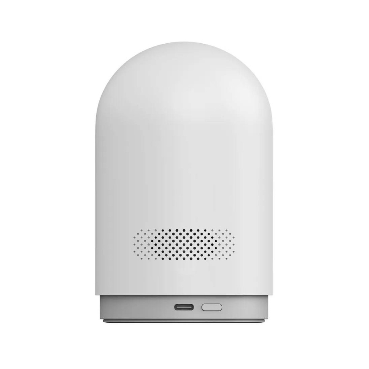 Białe, zaokrąglone urządzenie z szarą podstawą. Posiada kratkę głośnika z małymi otworami i dwa porty na dole.
