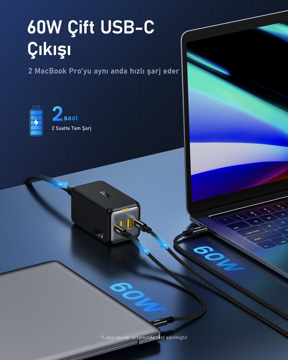 Bir dizüstü bilgisayar ve bir tablet, iki USB-C kablosuyla bir güç adaptörüne bağlıdır. Adaptör 120W çıkışa sahiptir.