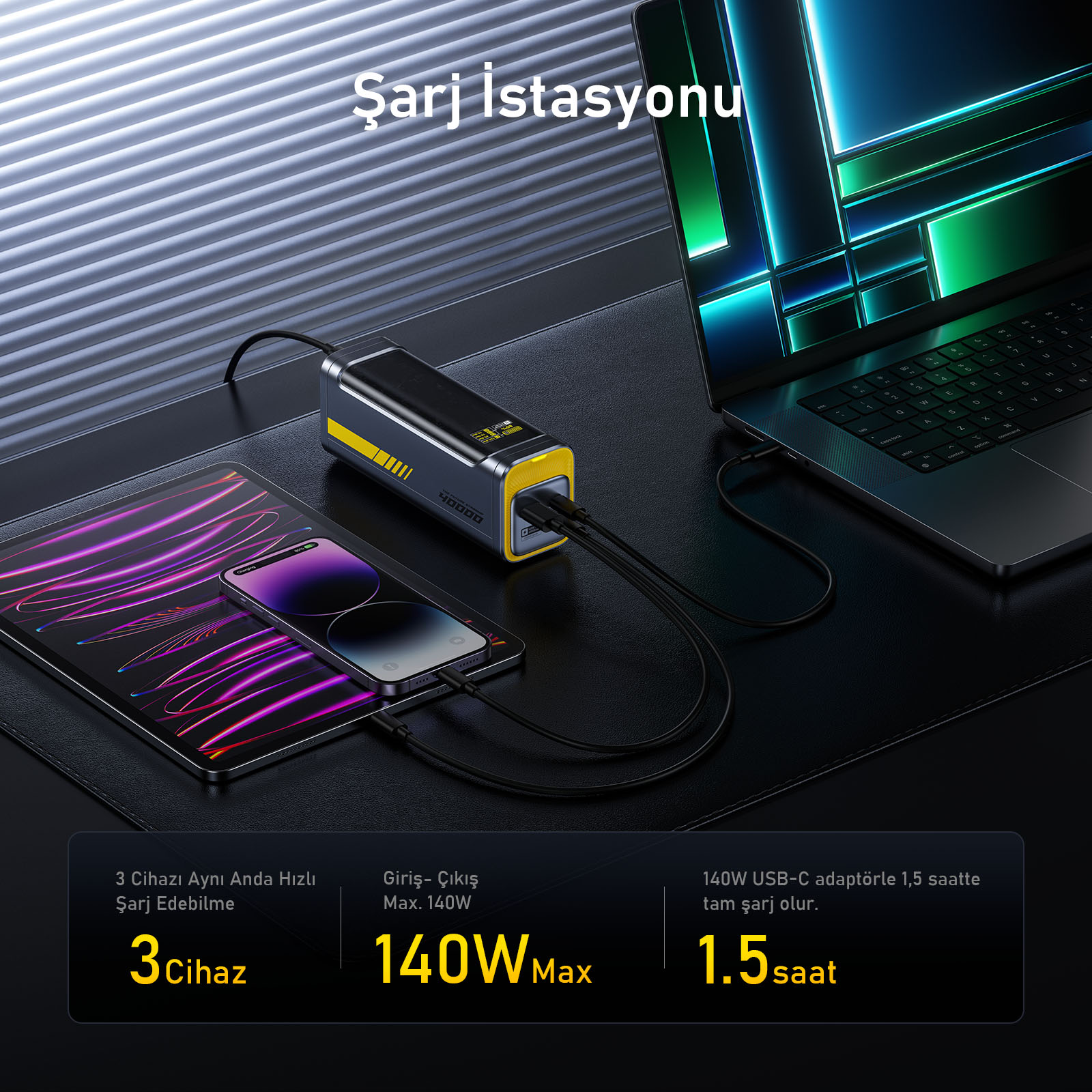 Dizüstü bilgisayar, tablet ve telefon bağlı bir şarj istasyonu. İstasyon siyah ve sarı renktedir.