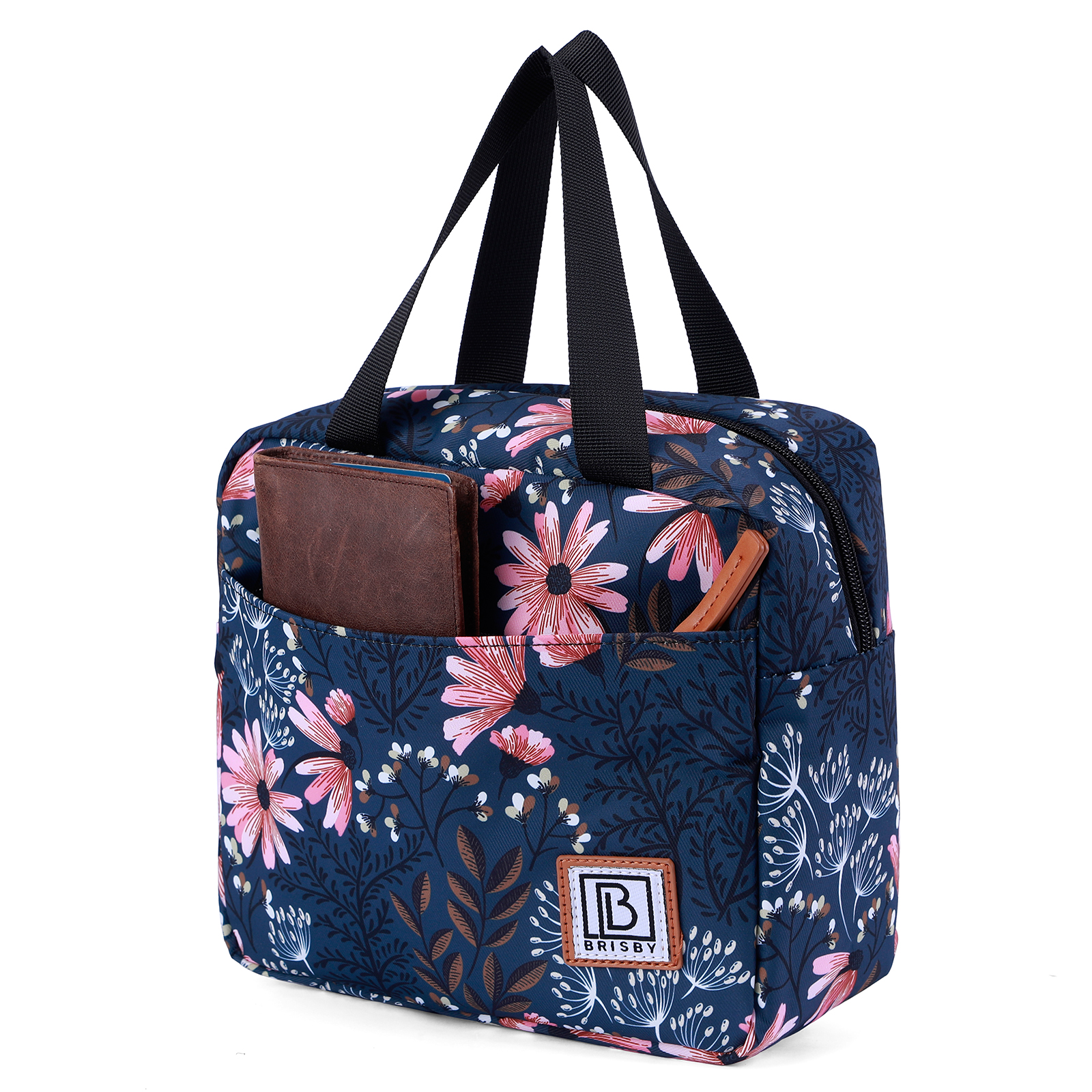 Een bloemen lunchtas met een bruine portemonnee en een pen in de voorzak. Zwarte handvatten en een witte achtergrond.