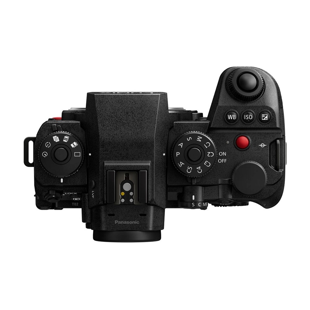 Black camera top view. Dials, buttons, and a hot shoe are visible. Panasonic logo is present. The design indicates a professional camera.