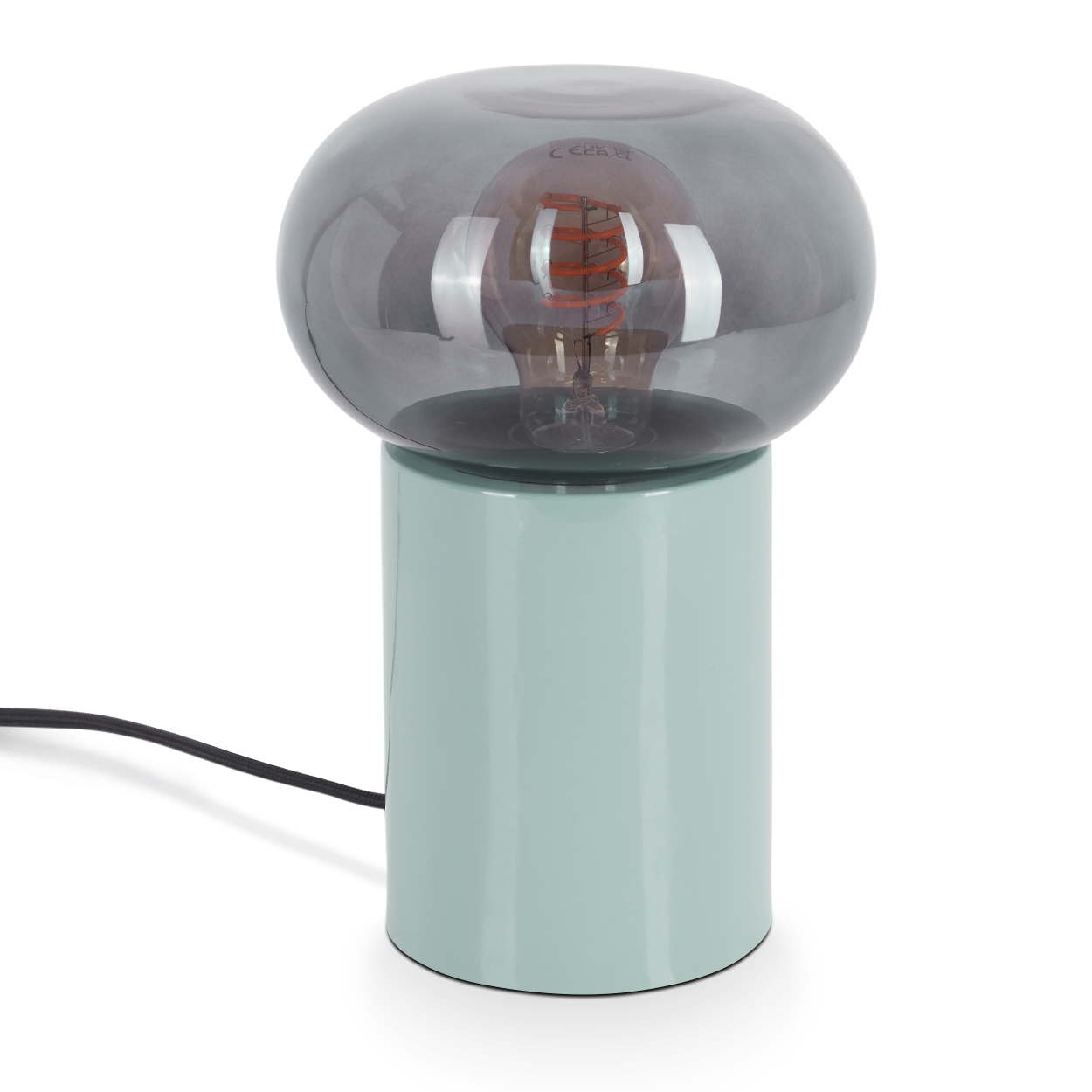 Eine moderne Tischlampe mit mintgrünem Sockel, grauem Glasschirm und sichtbarer Glühbirne. Ein schwarzes Netzkabel erstreckt sich nach links.