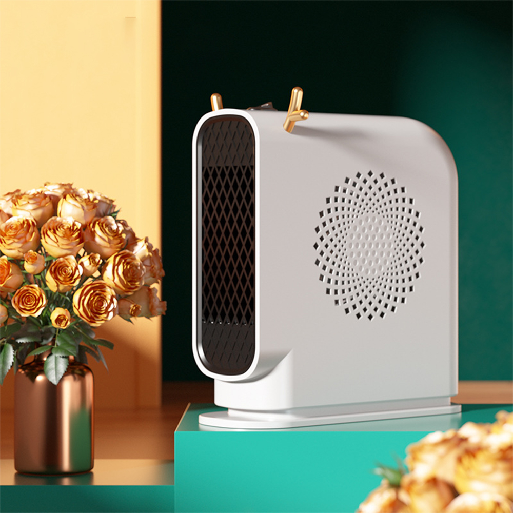 Ein weißer Elektroheizer mit goldfarbenen Zierelementen neben einer Vase mit orangefarbenen Rosen. Der Hintergrund ist gelb und grün.