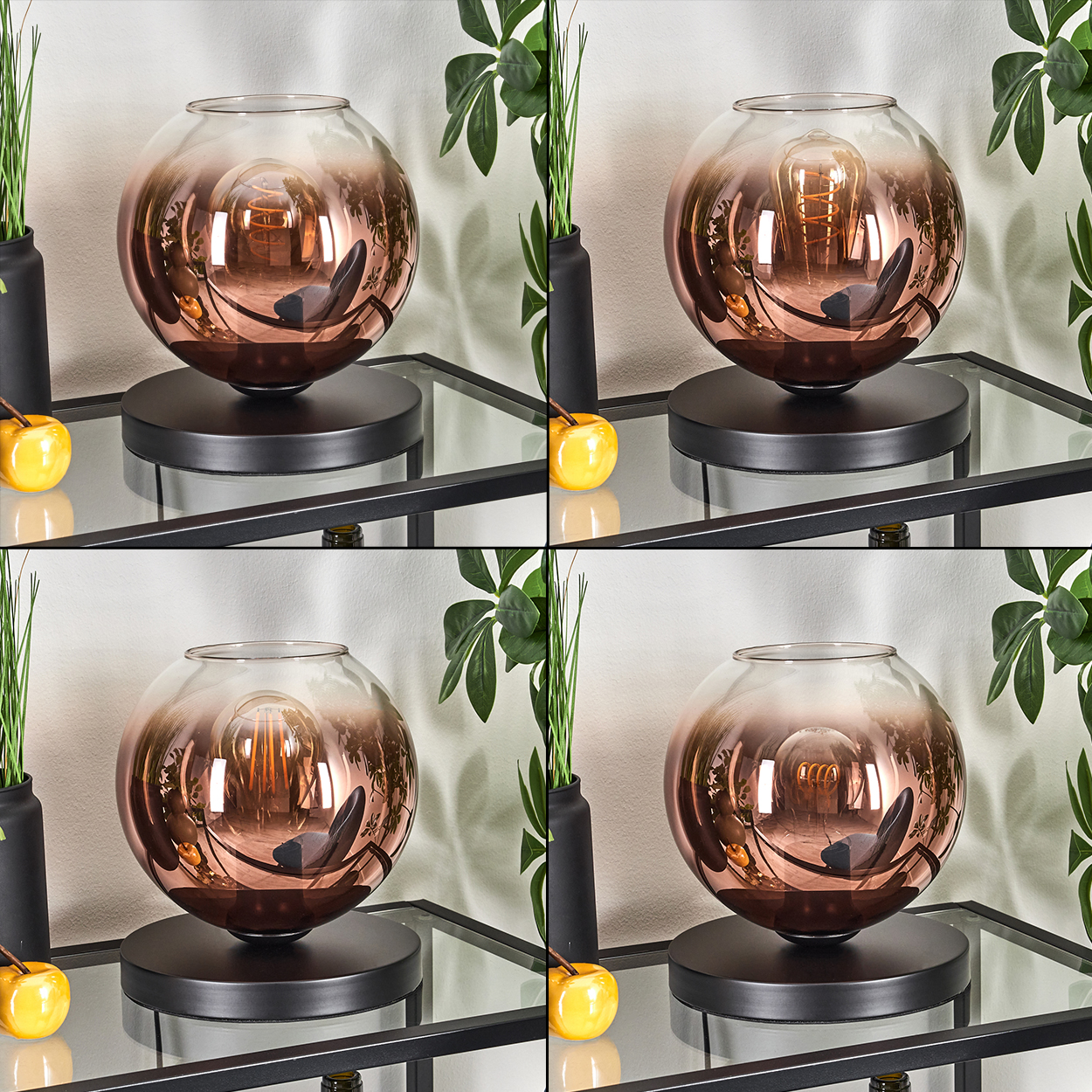 Eine dekorative Lampe mit kupferfarbenem Glasschirm. Sie steht auf einem schwarzen Ständer auf einem Glastisch. Grüne Pflanzen im Hintergrund.