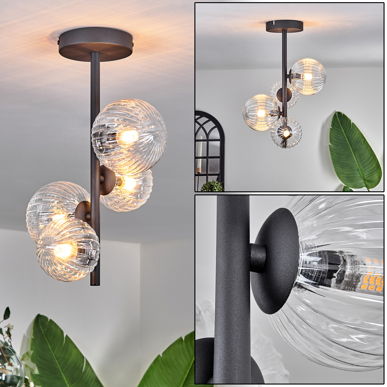 Moderne Deckenleuchte mit drei Glaskugelleuchten. Dunkle Metallstruktur hängt von der Decke. Eine Pflanze befindet sich im Vordergrund.