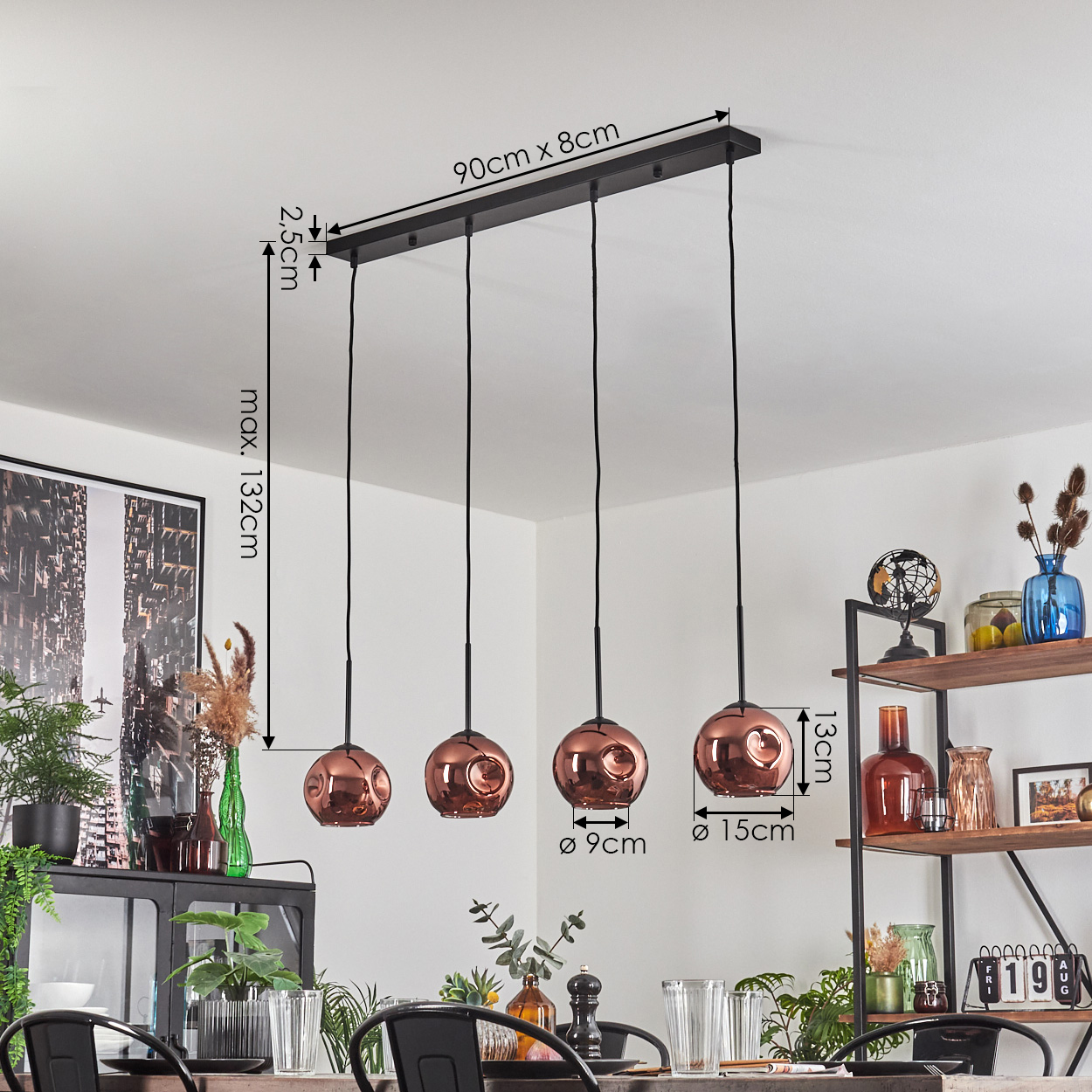 Ein Esszimmer mit kupferfarbener Pendelleuchte. Die Abmessungen sind angegeben. Es gibt Pflanzen, Regale und einen Tisch.