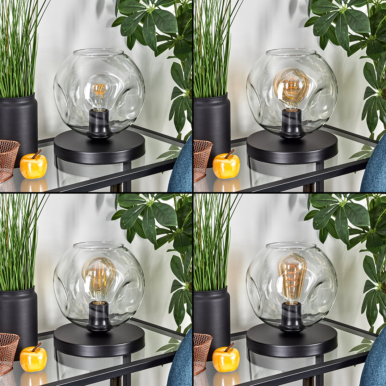 Eine dekorative Lampe mit Glasschirm und sichtbarer Glühbirne, auf einem schwarzen Tisch mit Pflanzen und Äpfeln.