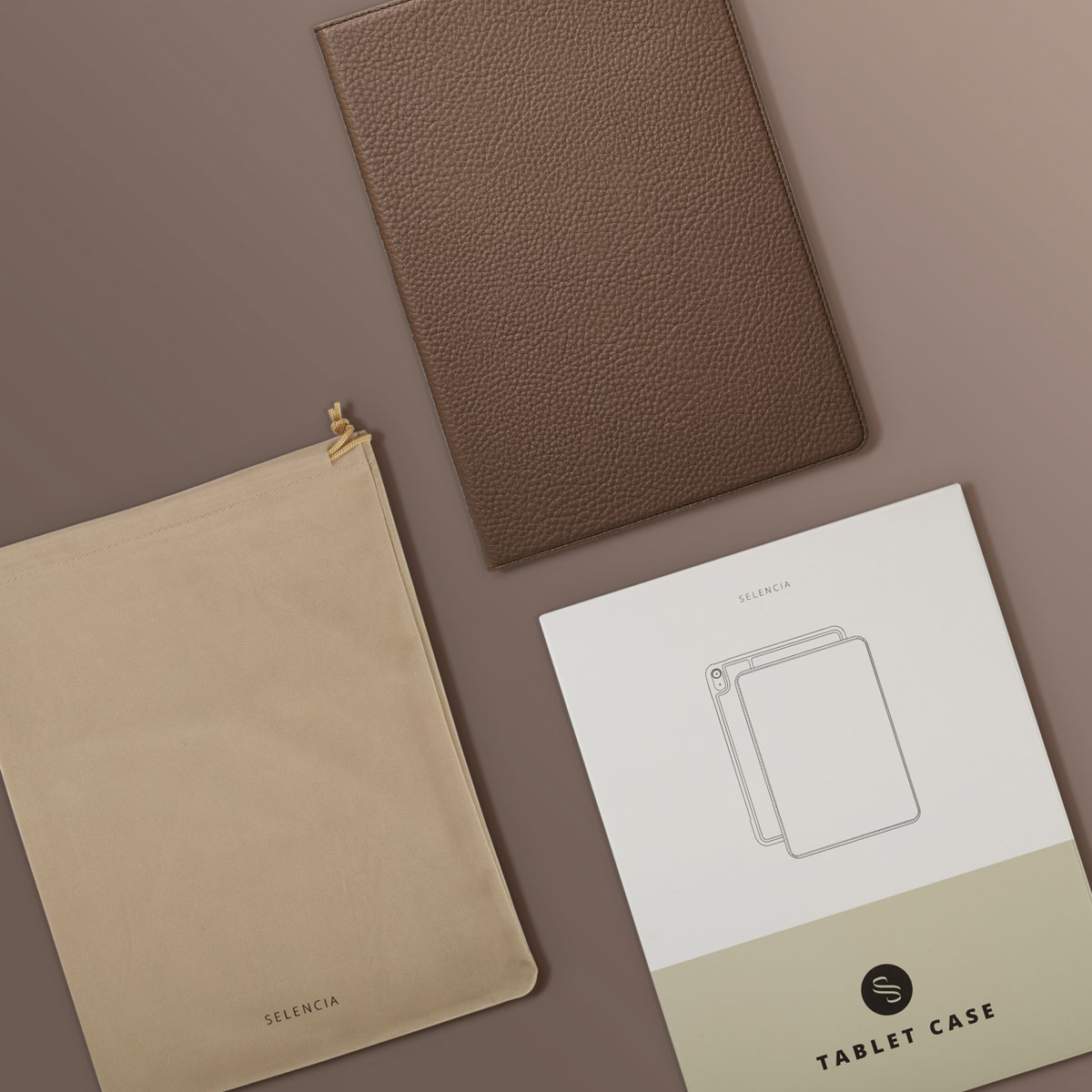 A brown leather tablet case, a beige pouch, and a white tablet case box with the brand name 'Selencia' on a brown background.