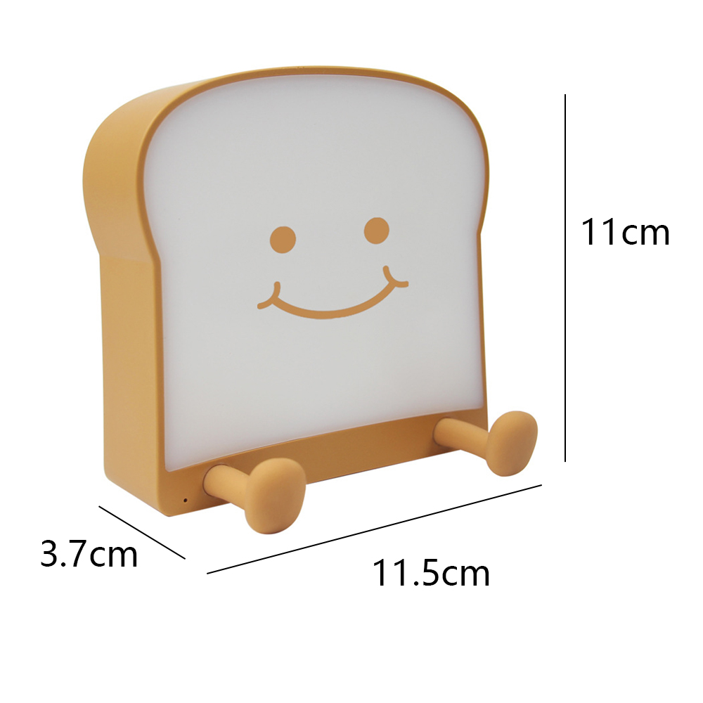 Ein brotförmiges Nachtlicht mit einem lächelnden Gesicht. Es hat zwei Beine und die Maße: 11 cm hoch, 11,5 cm breit und 3,7 cm tief.