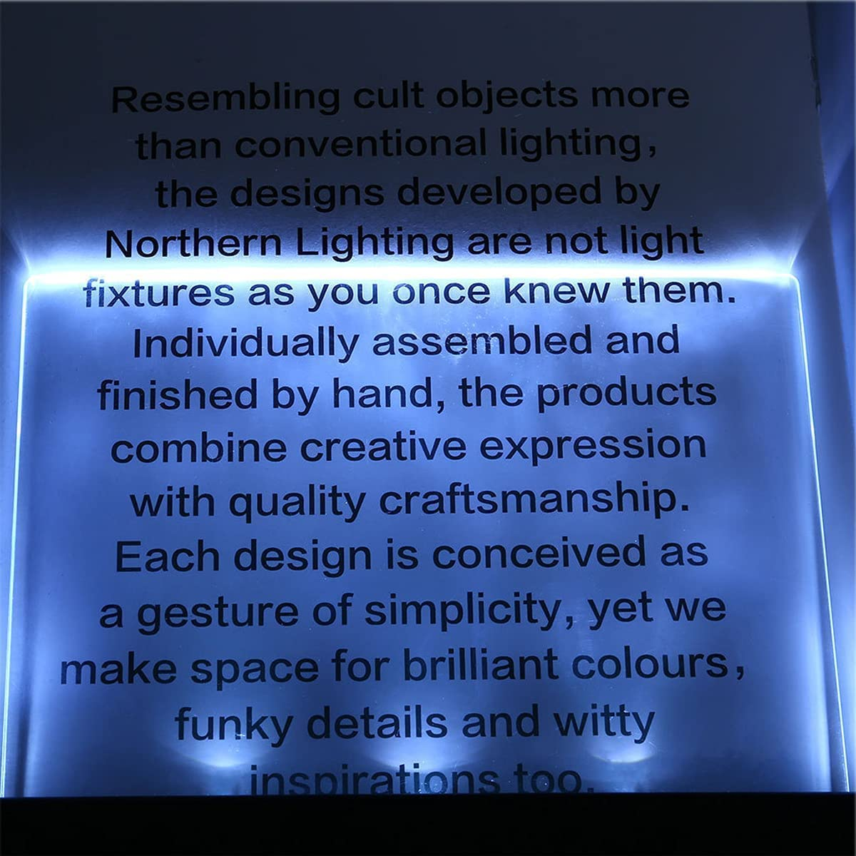 Text auf blau beleuchteter Oberfläche. Beschreibt einzigartige, handgefertigte Designs von Northern Lighting, Fokus auf Kreativität.