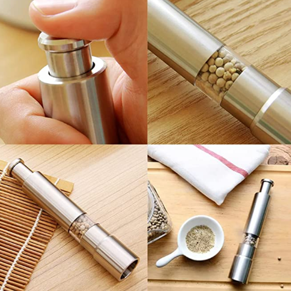 Nahaufnahme einer Pfeffermühle aus Edelstahl mit Pfefferkörnern. Andere Teile zeigen gemahlenen Pfeffer und ein weißes Handtuch.