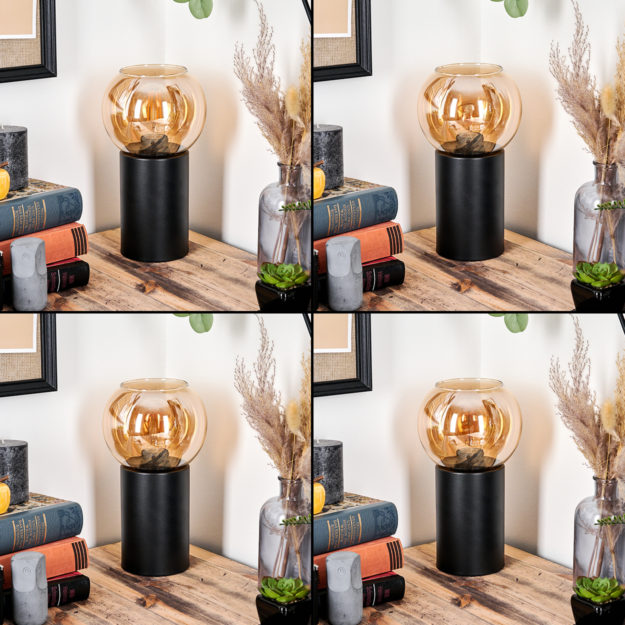 Auf einem Tisch stehen eine Lampe, Bücher, eine Vase mit Pflanzen, eine Kerze und eine Eulenfigur. Die Lampe hat einen schwarzen Sockel und eine Glaskugel.
