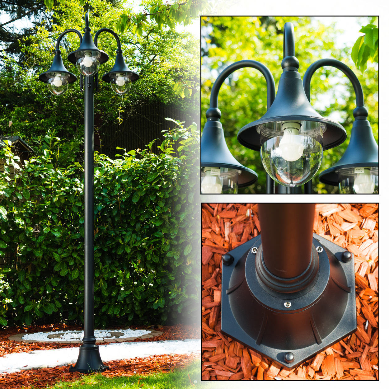 Eine schwarze Laterne mit drei Lampen befindet sich in einem Garten. Der Hintergrund ist eine grüne Hecke und Bäume. Der Boden hat Holzschnitzel.