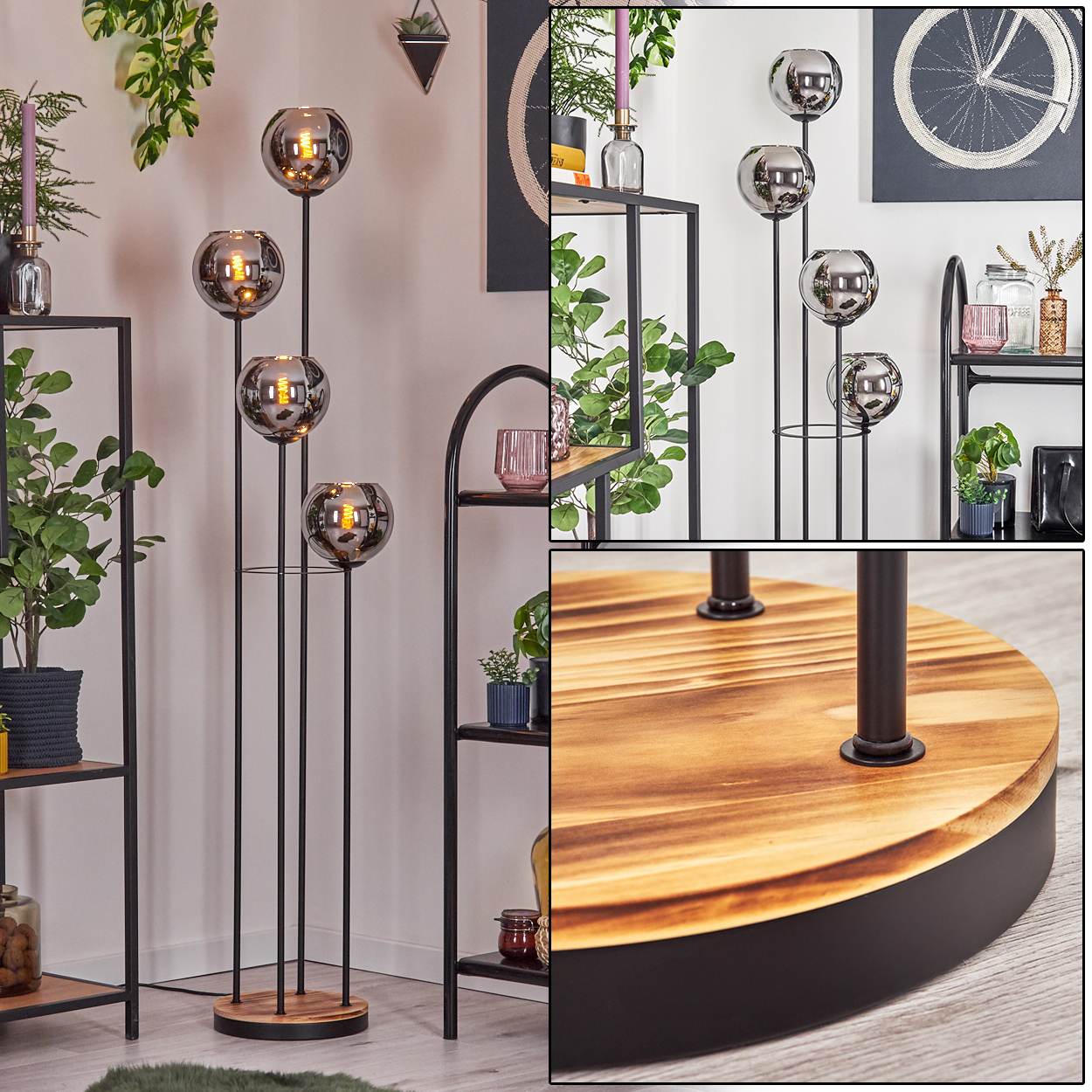 Eine moderne Stehlampe mit vier Glaskugelschirmen. Die Lampe ist schwarz mit einem Holzsockel. Regale mit Pflanzen sind im Hintergrund.