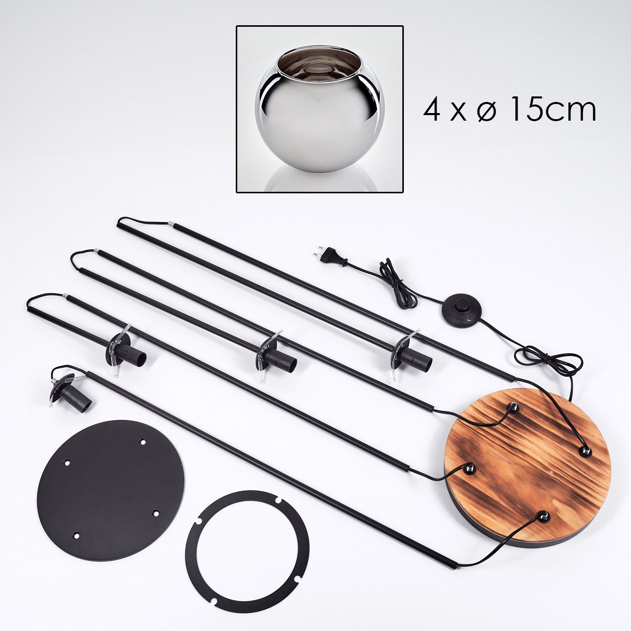 Zerlegte Lampenkomponenten: schwarze Stäbe, Holzsockel, Metallteile, eine runde Glasschale und ein Netzkabel.