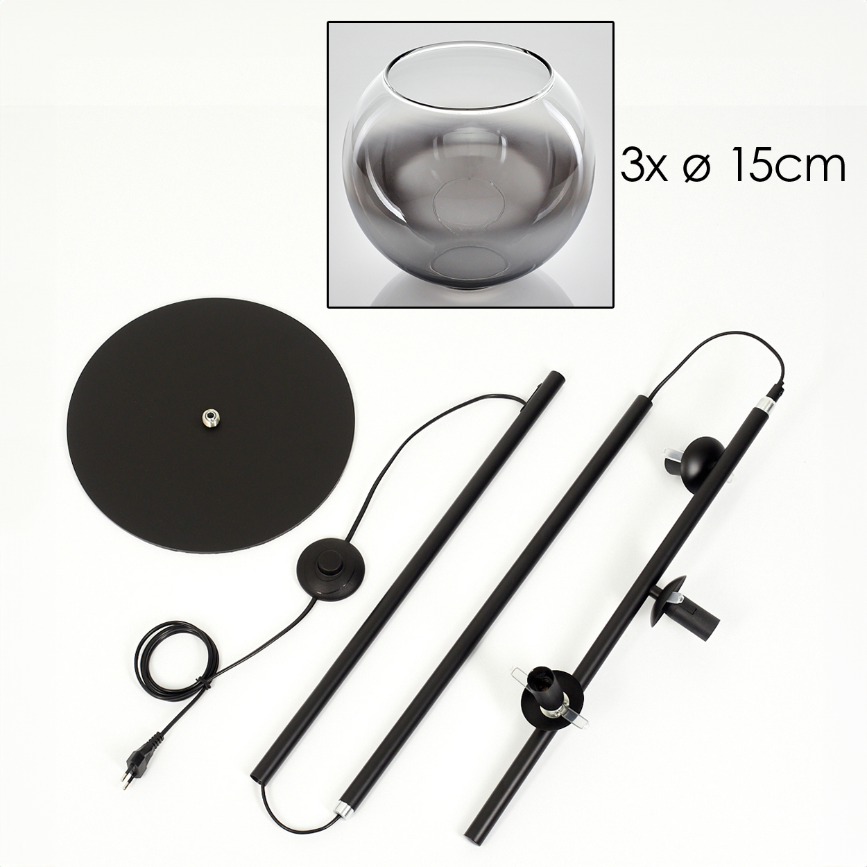 Zerlegte schwarze Stehlampe mit rundem Sockel, zwei Stangen und einer Glasschale. Text: 3 Schalen, 15 cm Durchmesser.