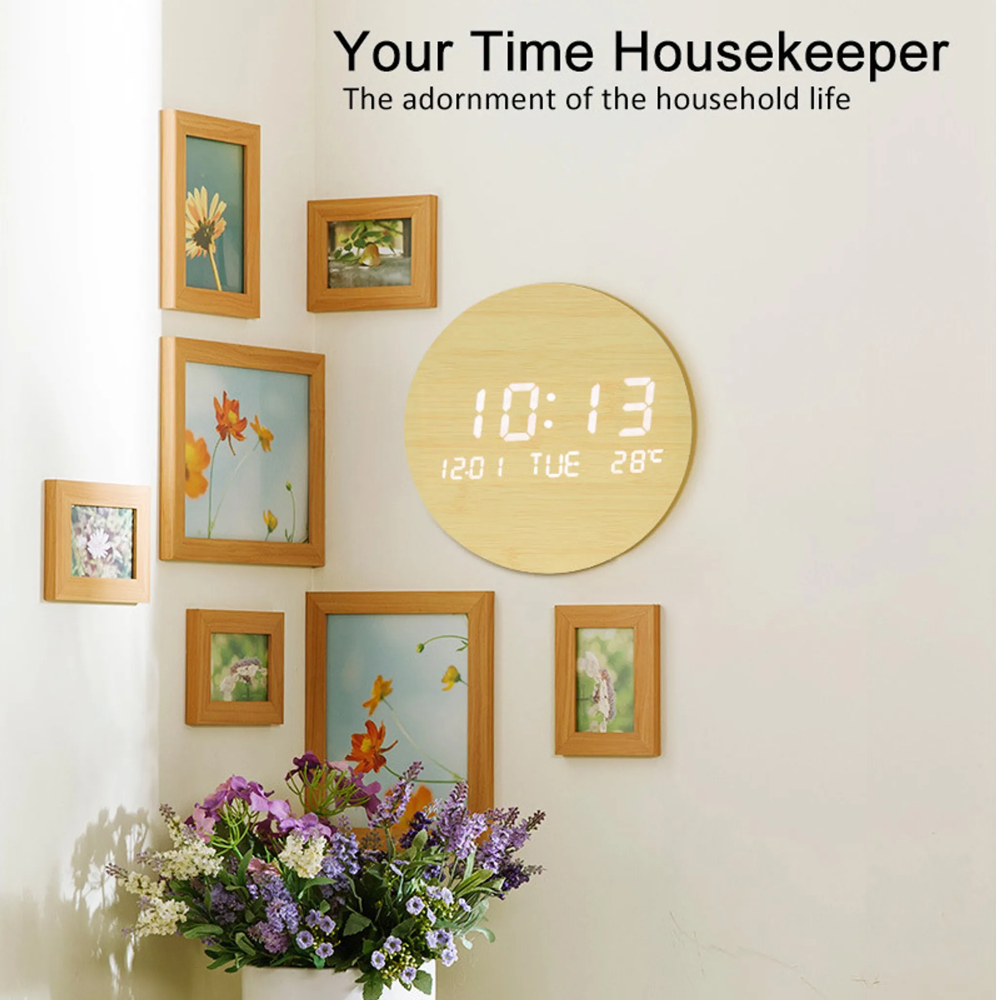 Holzgerahmte Bilder an einer Wand. Eine runde Uhr zeigt die Uhrzeit. Eine Vase mit Blumen befindet sich im Vordergrund.