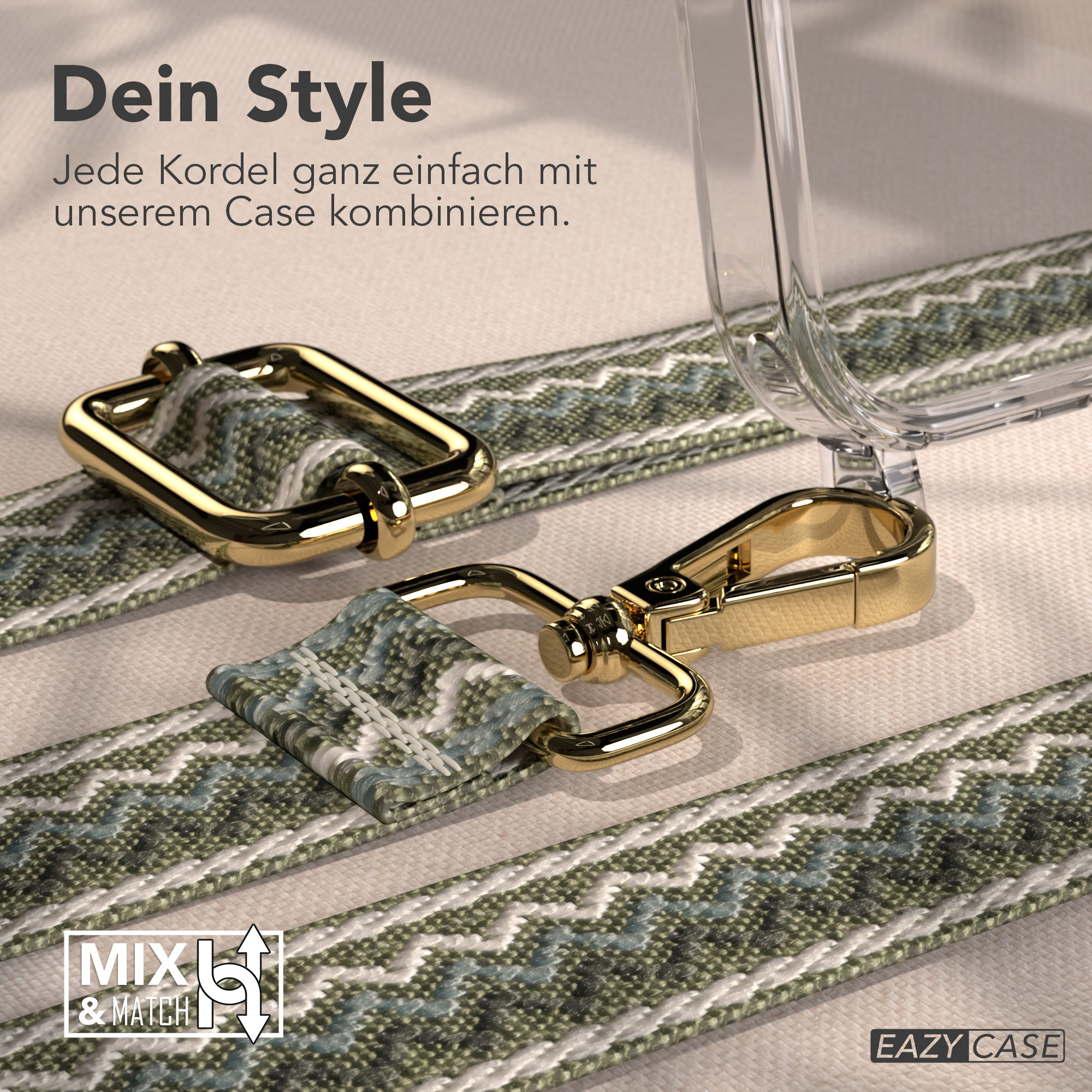 Goldene Hardware und gemusterter Riemen auf beigem Untergrund, mit einer transparenten Handyhülle im Hintergrund.