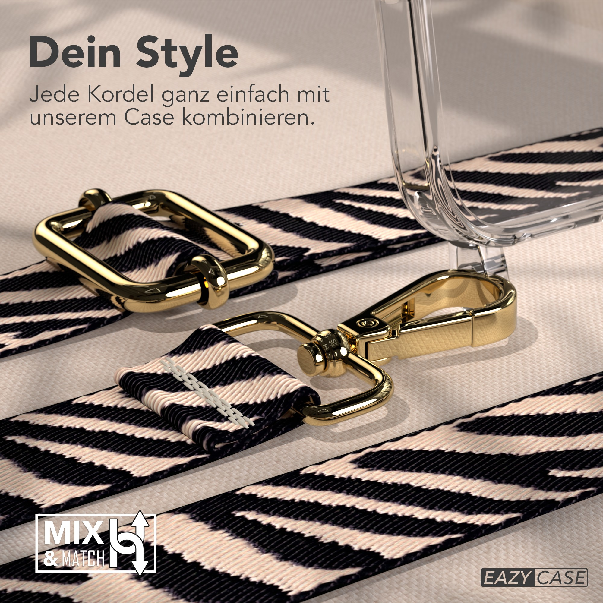 Nahaufnahme eines Telefonriemens mit Zebrastreifenmuster und goldenen Metallverschlüssen auf beigem Untergrund.