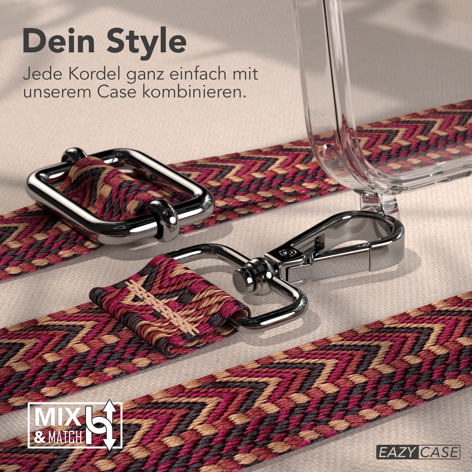 Nahaufnahme eines Riemens mit geometrischem Muster, silbernen Verschlüssen und einer transparenten Handyhülle auf beigem Untergrund.