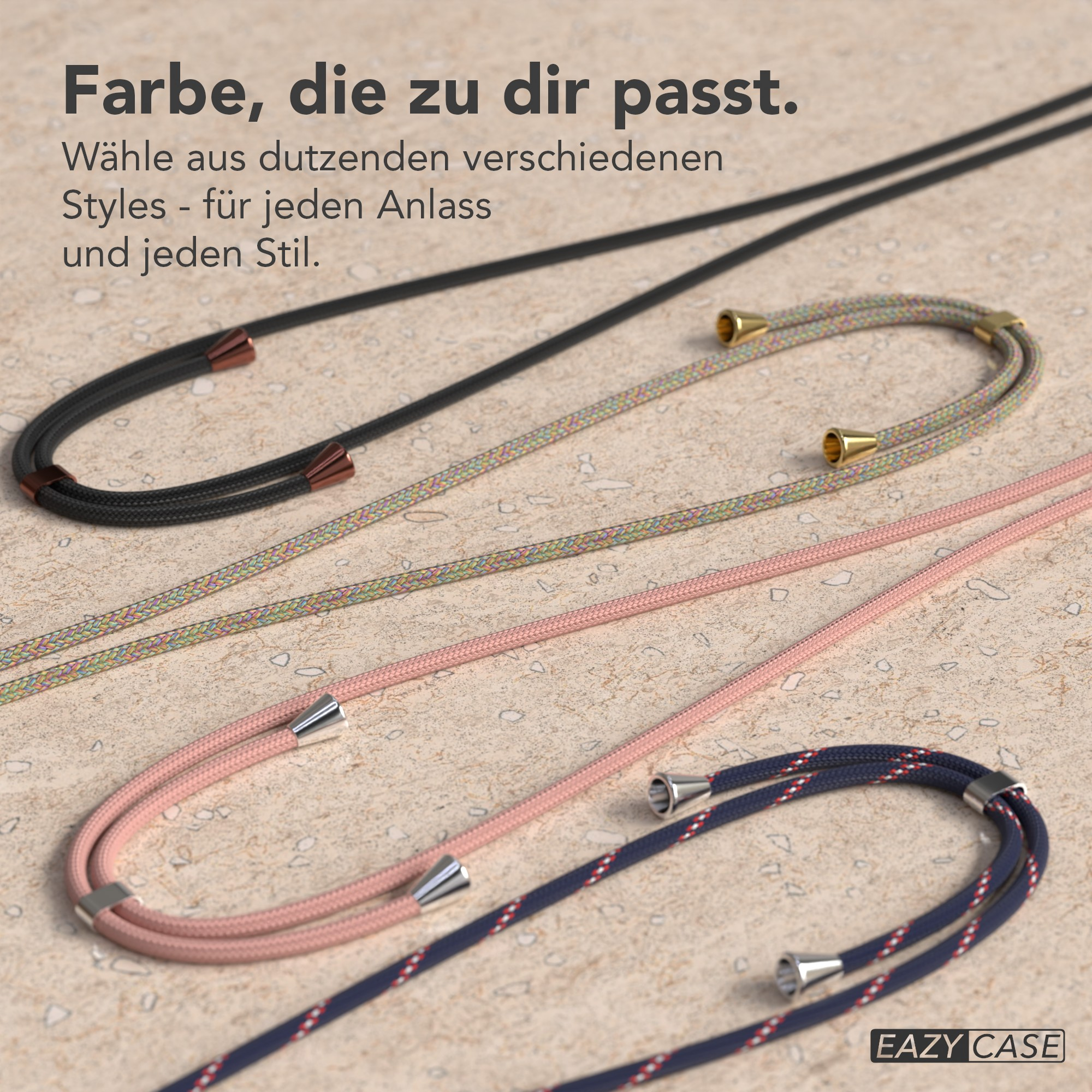 Das Bild zeigt Handystraps in Schwarz, Pink, Multicolor und Marineblau. Der Hintergrund ist eine beigefarbene Oberfläche.